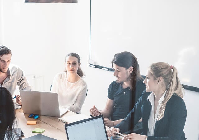 A group of people around a conference table
