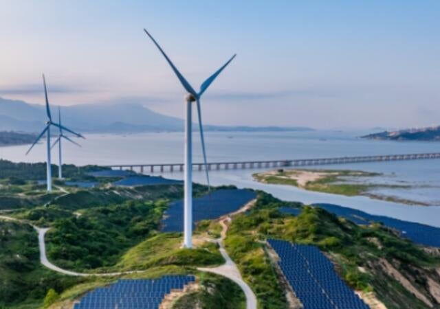 Windmills along a shoreline