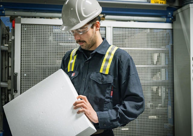 Engineer holding a block of polystyrene