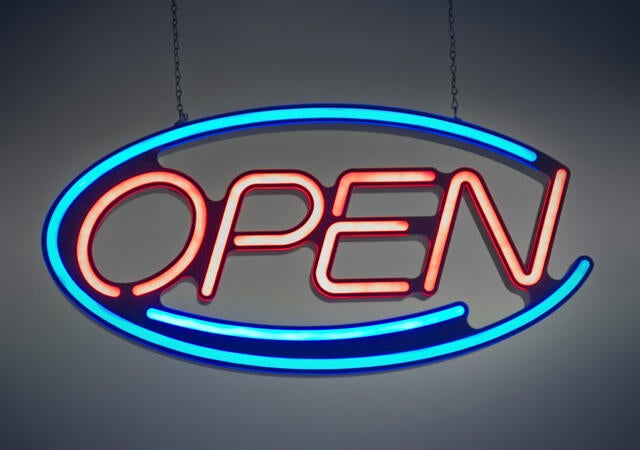 A neon sign that says open