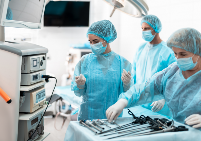 Three medical workers in a surgical suite