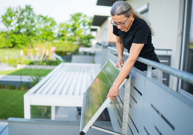Woman adjusting solar panel