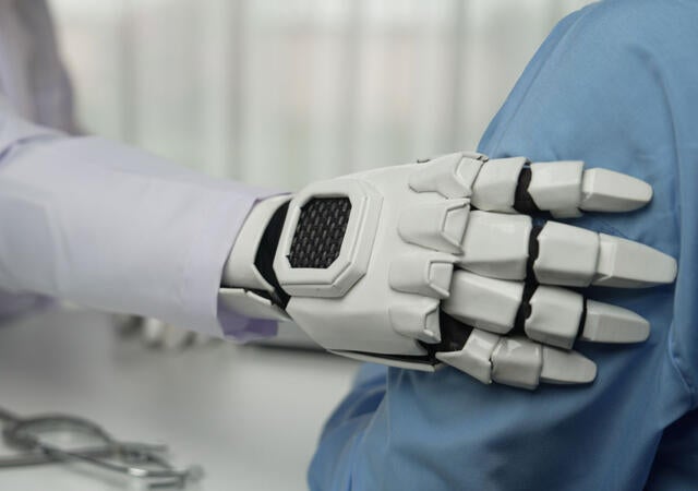 a robotic arms resting on a person's arm