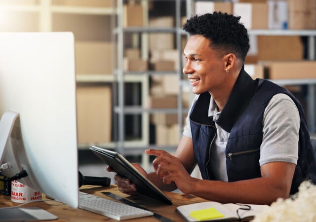 A person using a tablet to look up logistic information