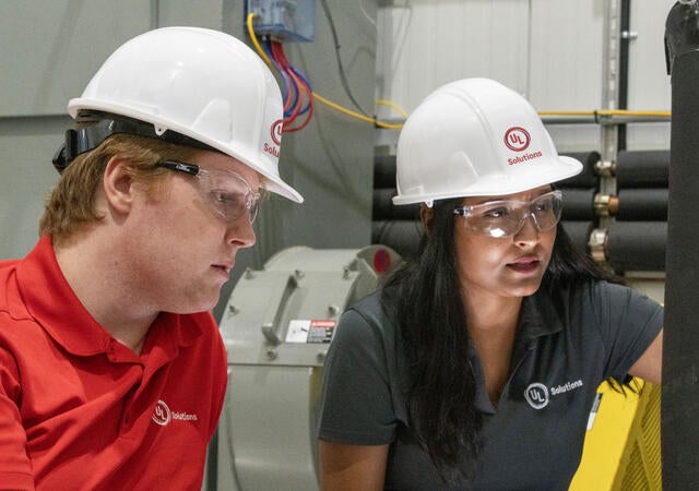 Two people working at the Plano HVAC laboratory
