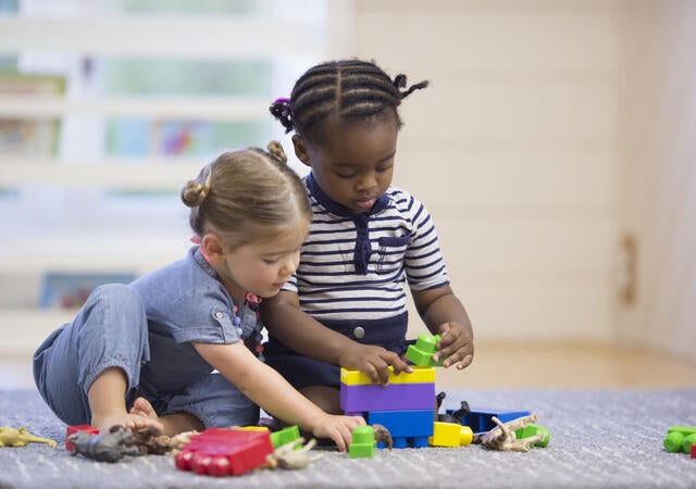 Two young children playing with toys
