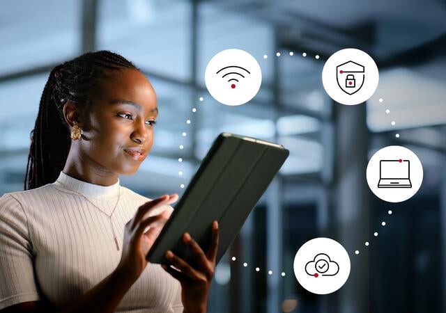 Woman working on a tablet, cybersecurity icons floating around tablet