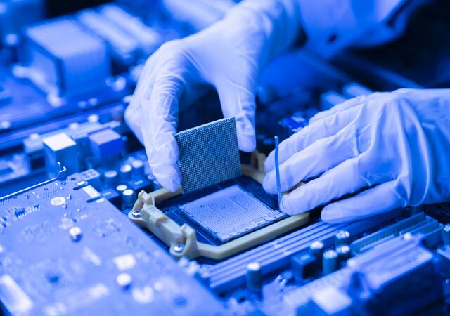 Person installing a processor into the CPU socket