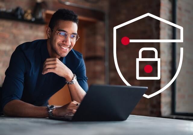 A smiling person using a secure laptop