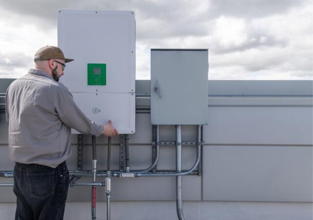 A person working on a breaker box