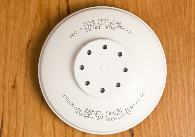 Smoke detector on a wooden surface