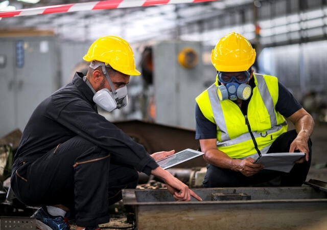 Two engineers inspecting electrical equipment