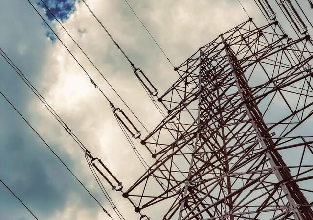 Upward view of a pylon and power lines