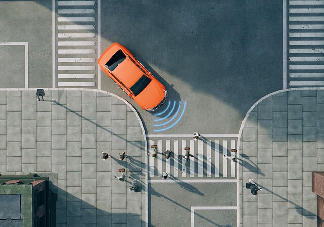 Graphic depiction of a car using autonomous driving features to stop at a busy crosswalk