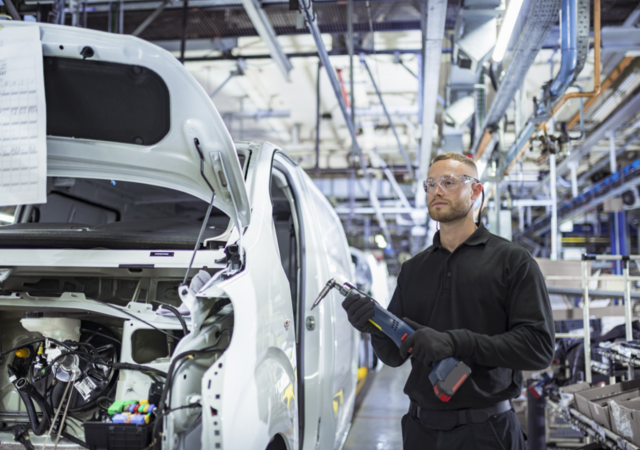 A person working in an automotive manufacturing facility