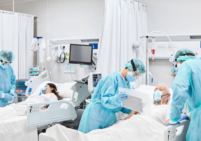 People working in a hospital suite