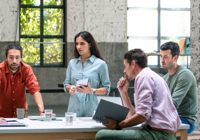 Group of businessmen and businesswomen cooperating at work