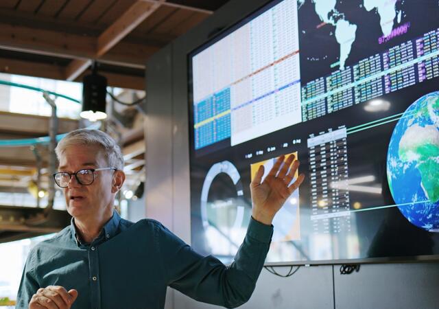 person showing hand to the screen while explaining