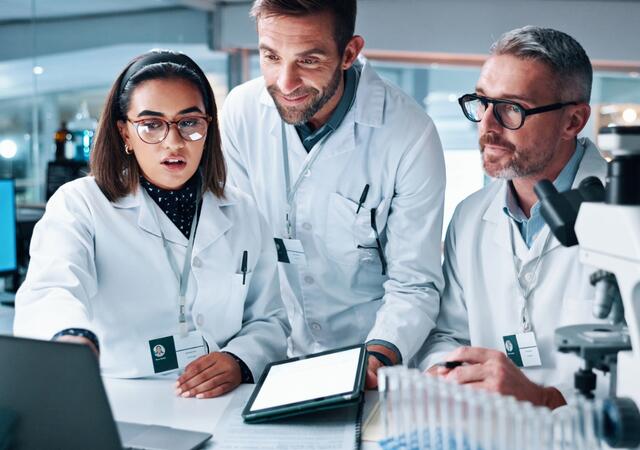  Close-Up of Team Reviewing Data on a Computer in Laboratory