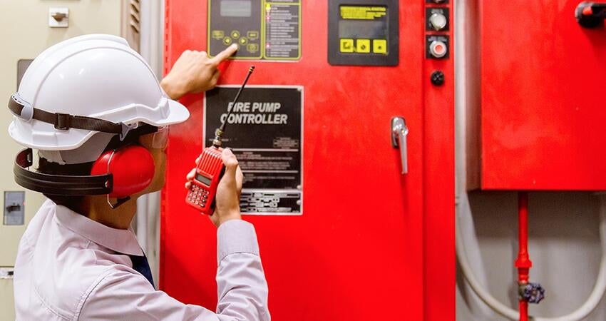 An inspector looks at a fire pump