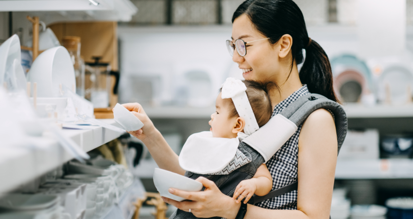 Woman shopping for dishes with her baby
