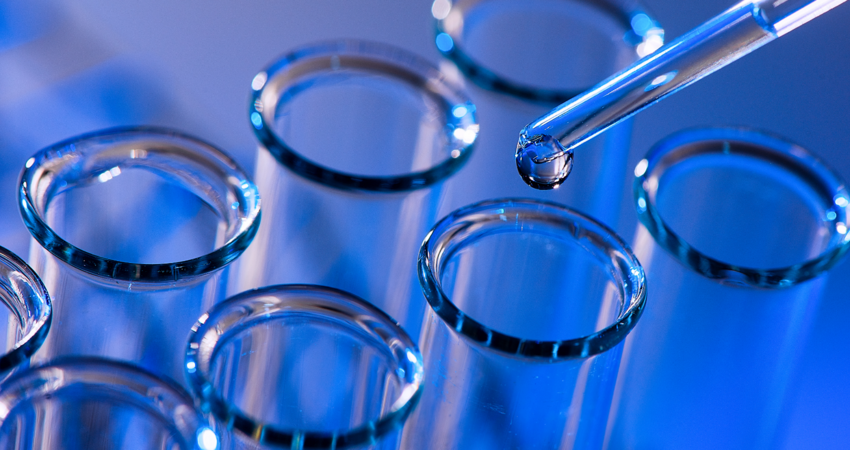Close-Up Of Water Drops On Glass Test Tube
