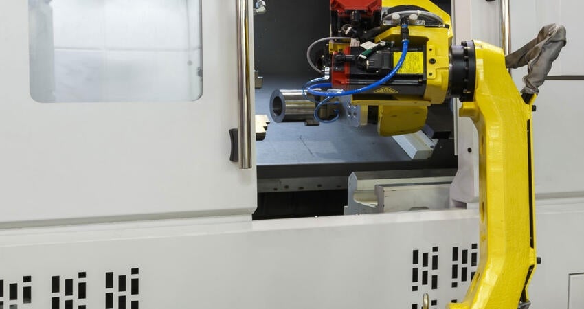 Automated CNC machine loading with a robotic arm