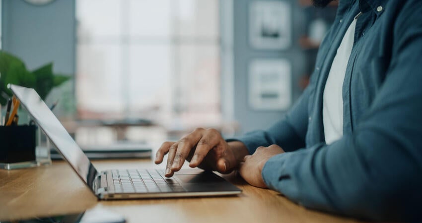 A person typing on a laptop