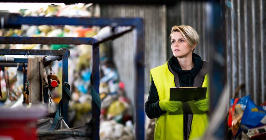 Worker in landfill.