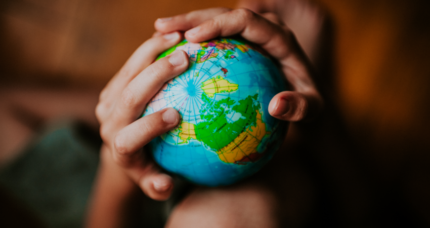 Child holding a globe.