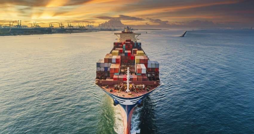 Aerial front view Container cargo ship full carrier container with terminal commercial port background for business logistics, import export, shipping or freight transportation.