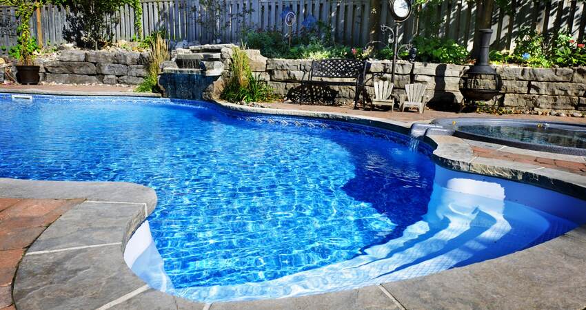Swimming pool accented with a waterfall.