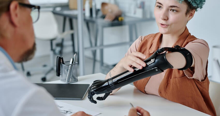 A patient discusses a prosthetic limb with the doctor