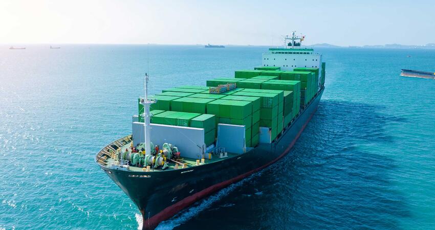 Full cargo ship making its way into port 