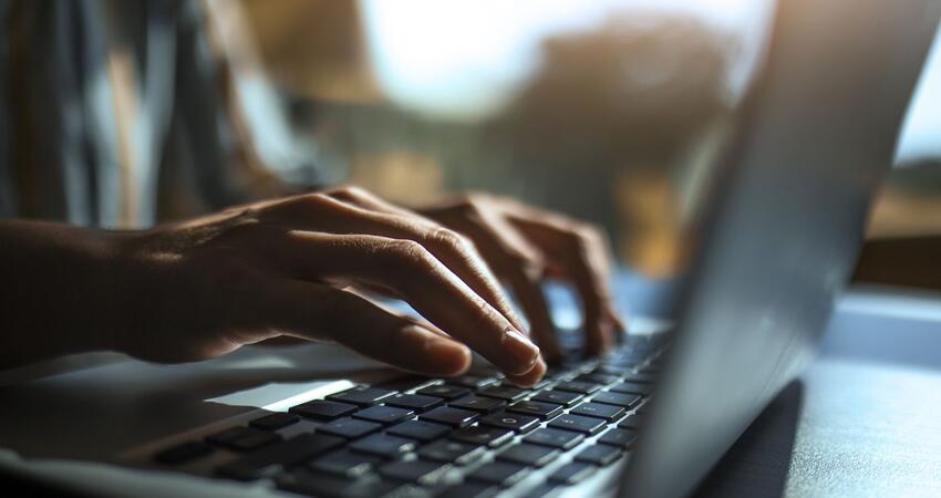 Man typing on laptop