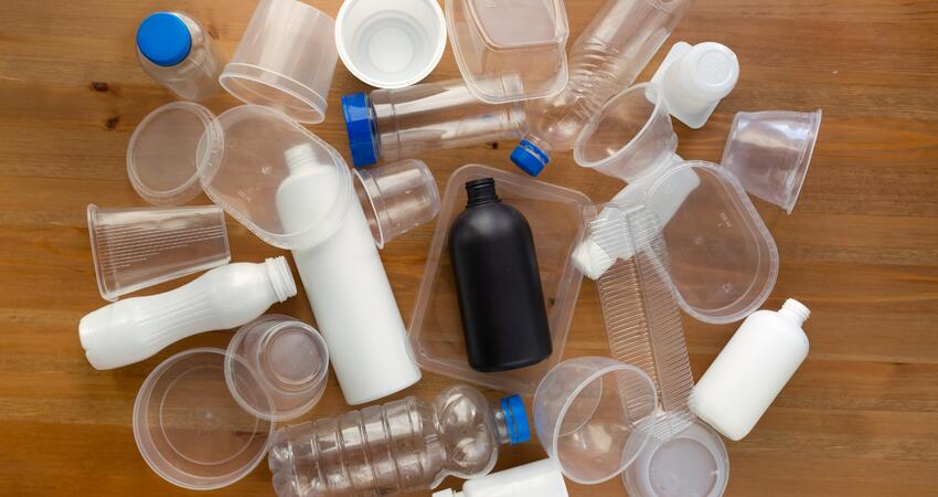 A pile of empty, unlabeled bottles and containers with corresponding lids. 