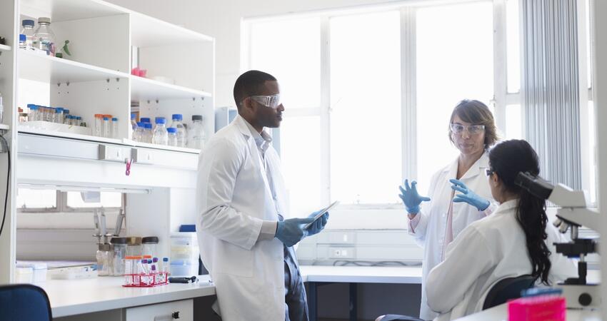 Scientists talking together in a laboratory