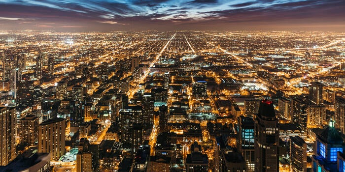 Cityscape at night with many lights from homes, businesses, roads