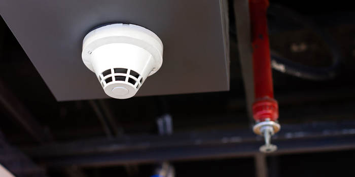 Smoke detector and fire sprinkler on the ceiling