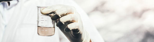 Close-up of person testing water sample.