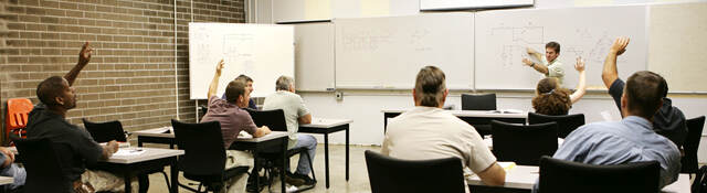 A classroom of individuals learns more about hazardous location training. 