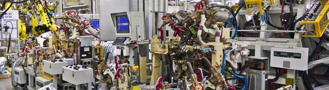 Robotic machines in a factory setting. 