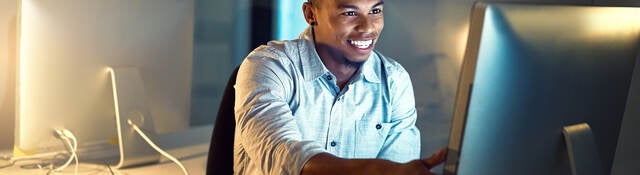 Shot of a young businessman working late in an office