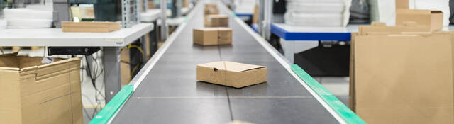 Photo of cardboard boxes on a conveyor belt