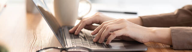 woman typing on a laptop keyboard