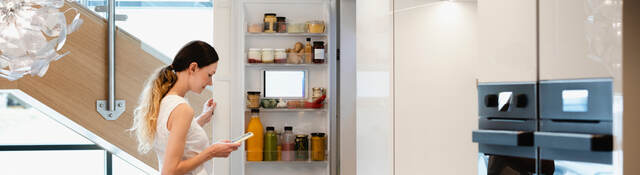 Woman looking into her fridge