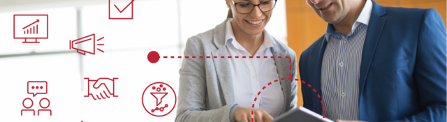 Two employees reviewing data on a tablet with icons around them