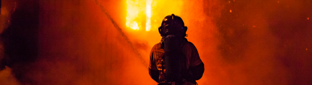 Firefighter and fire at night