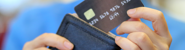 Woman pulling a credit card out of a wallet