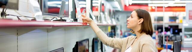 woman buying a TV in a retail store